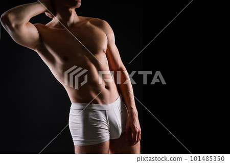 Shirtless bodybuilder holding dumbell and showing his muscular arms. Shirtless bodybuilder holding dumbell and showing his muscular arms. 101485350