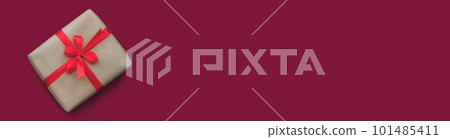 banner gift in craft paper and red ribbon with bow on crimson background 101485411