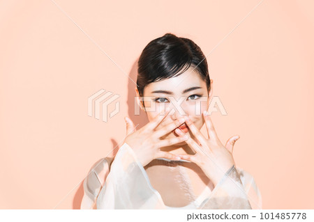 Portrait of a woman hiding her face Portrait of a woman hiding her face 101485778
