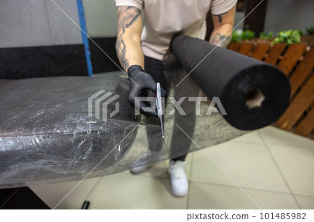Asian tattoo master preparing couch for tattoo session 101485982