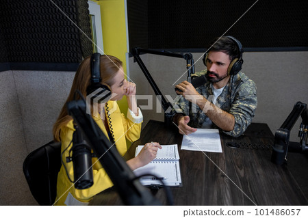 Radio dj talking to a young singer at the radio station 101486057