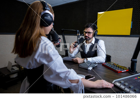 Radio dj talking to a young singer at the radio station 101486066