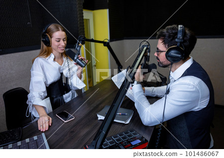Radio dj talking to a young singer at the radio station Radio dj talking to a young singer at the radio station 101486067