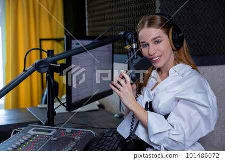 Long-haired young woman recording a soundtrack at the studio 101486072