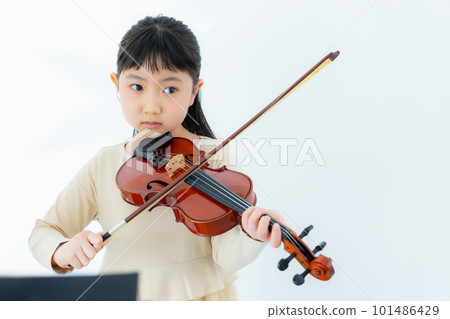 A child playing the violin A child playing the violin 101486429