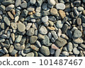 Different color beach stone pebbles at seashore outdoors top view. Abstract smooth round pebbles sea 101487467