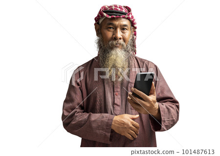Muslim man with a beard wearing keffiyeh with agal using mobile phone 101487613
