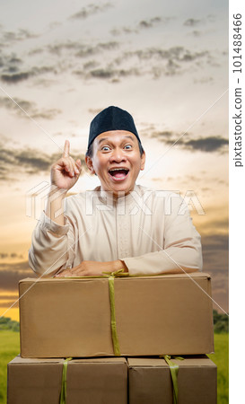 Asian Muslim man with a box thinking about mudik 101488466