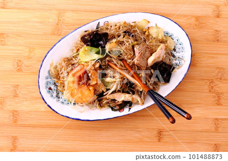 Asian rice noodle dish with shrimp, chicken and vegetables, top view. High quality photo 101488873