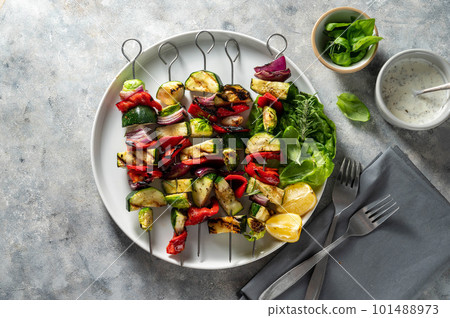 Grilled vegetable kebabs, skewers with zucchini, bell peppers, bruxelle cabbage and red onions. 101488973