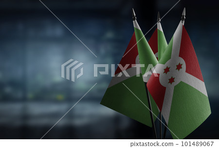 Small flags of the Burundi on an abstract blurry background 101489067