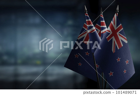 Small flags of the New Zealand on an abstract blurry background 101489071