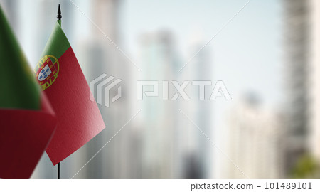 Small flags of the Portugal on an abstract blurry background 101489101