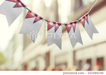 A garland of Nepal national flags on an abstract blurred background 101489140