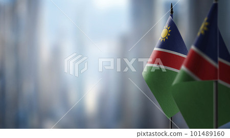 Small flags of the Namibia on an abstract blurry background 101489160