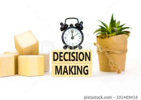 Decision making symbol. Concept words Decision making on wooden blocks. Beautiful white table white background. Black alarm clock. Business and decision making concept. Copy space. Decision making symbol. Concept words Decision making on wooden blocks. Beautiful white table white background. Black alarm clock. Business and decision making concept. Copy space. 101489418