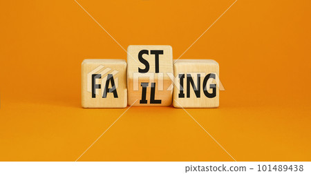 Fasting or failing symbol. Concept word Fasting Failing on wooden cubes. Beautiful orange table orange background. Business, healthy lifestyle and fasting or failing concept. Copy space. 101489438