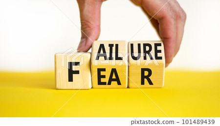 Fear of failure symbol. Businessman turns wooden cubes and changes the concept word Failure to Fear. Beautiful yellow table white background, copy space. Business and fear of failure concept. Fear of failure symbol. Businessman turns wooden cubes and changes the concept word Failure to Fear. Beautiful yellow table white background, copy space. Business and fear of failure concept. 101489439
