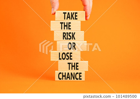 Risk or chance symbol. Concept words Take the risk or lose the chance on wooden blocks. Beautiful orange background. Copy space. Businessman hand. Motivational business risk or chance concept. Risk or chance symbol. Concept words Take the risk or lose the chance on wooden blocks. Beautiful orange background. Copy space. Businessman hand. Motivational business risk or chance concept. 101489500