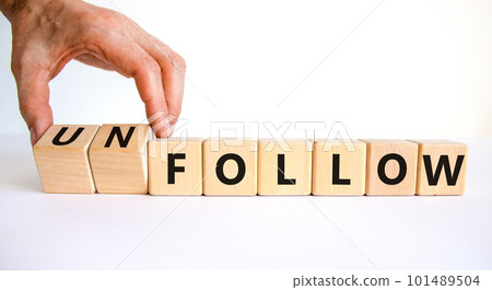 Follow or unfollow symbol. Businessman turns wooden cubes and changes words follow to unfollow. Beautiful white background, copy space. Business and follow or unfollow concept. Follow or unfollow symbol. Businessman turns wooden cubes and changes words follow to unfollow. Beautiful white background, copy space. Business and follow or unfollow concept. 101489504