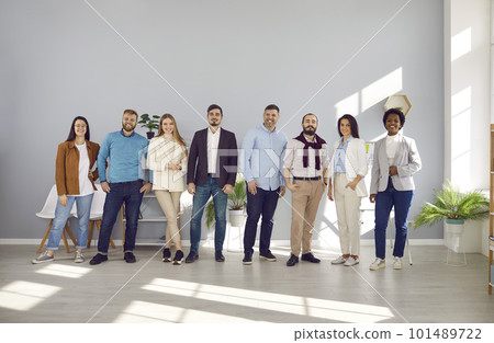 Happy multiracial representatives of modern business team posing together standing in row. 101489722