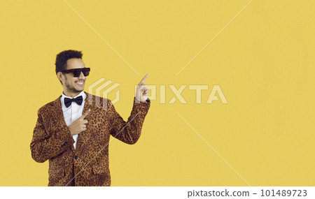 Happy man advertising something and pointing finger to side at copy space background Happy man advertising something and pointing finger to side at copy space background 101489723