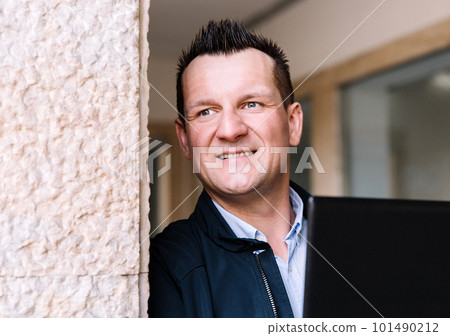 A confident business person with a laptop in the city. Business vision, communications, online shopping A confident business person with a laptop in the city. Business vision, communications, online shopping 101490212