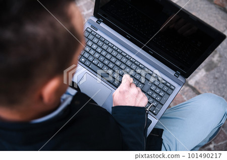 A confident business person with a laptop in the city. Business vision, communications, online shopping A confident business person with a laptop in the city. Business vision, communications, online shopping 101490217