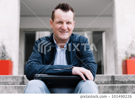 A confident business person with a laptop in the city. Business vision, communications, online shopping A confident business person with a laptop in the city. Business vision, communications, online shopping 101490226