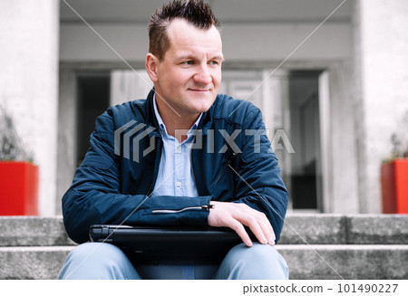 A confident business person with a laptop in the city. Business vision, communications, online shopping A confident business person with a laptop in the city. Business vision, communications, online shopping 101490227