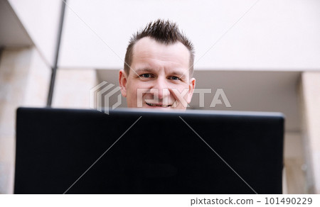 A confident business person with a laptop in the city. Business vision, communications, online shopping A confident business person with a laptop in the city. Business vision, communications, online shopping 101490229
