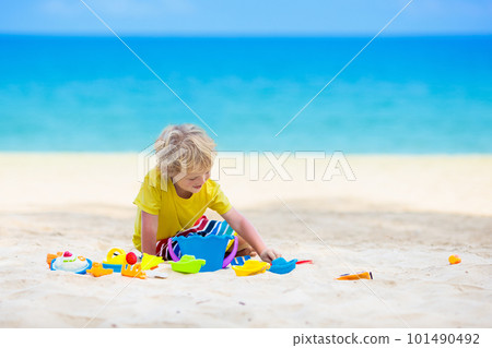 Kids playing on beach. Children play at sea. 101490492
