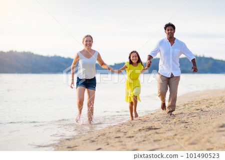 Family walking on tropical beach. Family walking on tropical beach. 101490523