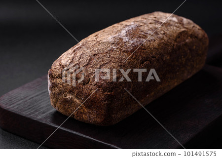 Loaf of fresh crispy brown bread with grains and seeds 101491575