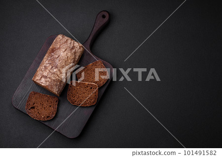 Loaf of fresh crispy brown bread with grains and seeds Loaf of fresh crispy brown bread with grains and seeds 101491582