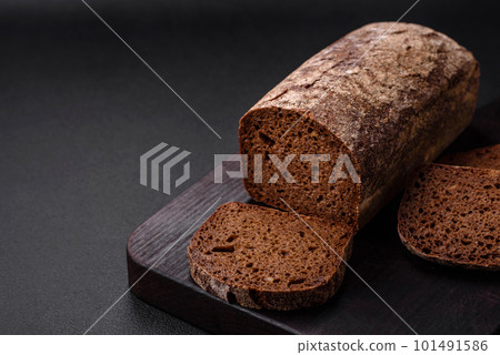 Loaf of fresh crispy brown bread with grains and seeds 101491586