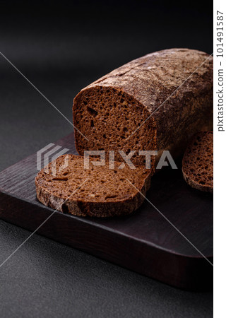 Loaf of fresh crispy brown bread with grains and seeds Loaf of fresh crispy brown bread with grains and seeds 101491587