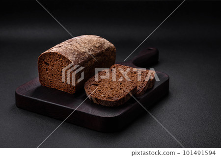 Loaf of fresh crispy brown bread with grains and seeds Loaf of fresh crispy brown bread with grains and seeds 101491594
