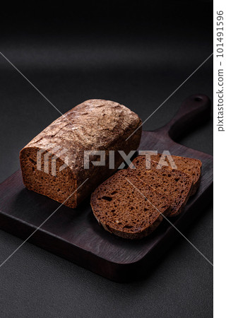 Loaf of fresh crispy brown bread with grains and seeds 101491596