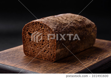 Loaf of fresh crispy brown bread with grains and seeds Loaf of fresh crispy brown bread with grains and seeds 101491600