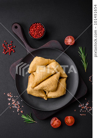 Delicious pancakes triangular shape with meat, salt and spices Delicious pancakes triangular shape with meat, salt and spices 101491654