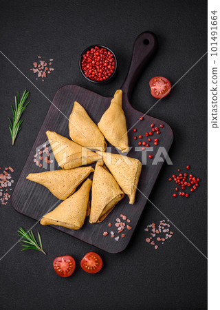 Delicious pancakes triangular shape with meat, salt and spices 101491664