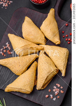 Delicious pancakes triangular shape with meat, salt and spices 101491665