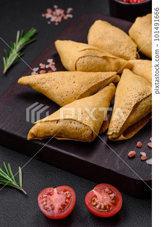 Delicious pancakes triangular shape with meat, salt and spices 101491666
