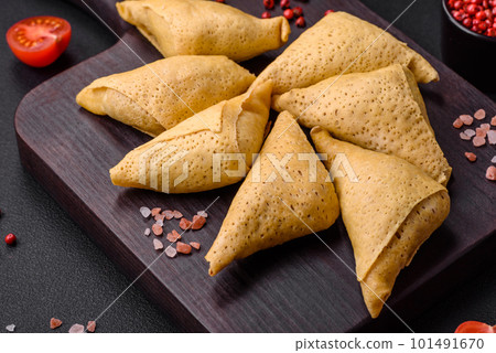 Delicious pancakes triangular shape with meat, salt and spices 101491670