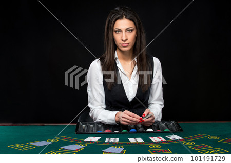The beautiful girl, dealer, behind a table for poker 101491729