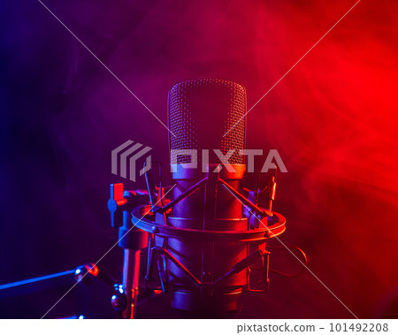 Professional microphone in pink smoke on a black background. Professional microphone in pink smoke on a black background. 101492208