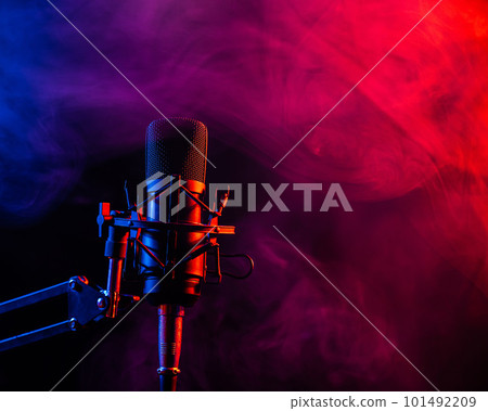 Professional microphone in pink smoke on a black background. 101492209