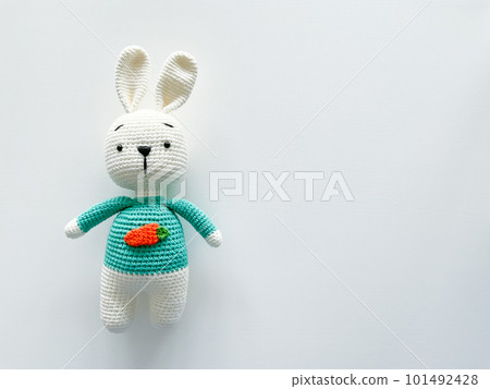 Soft white crochet bunny. on a white background. 101492428