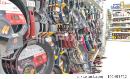 A blurry image of a home center displaying frying pans A blurry image of a home center displaying frying pans 101495732
